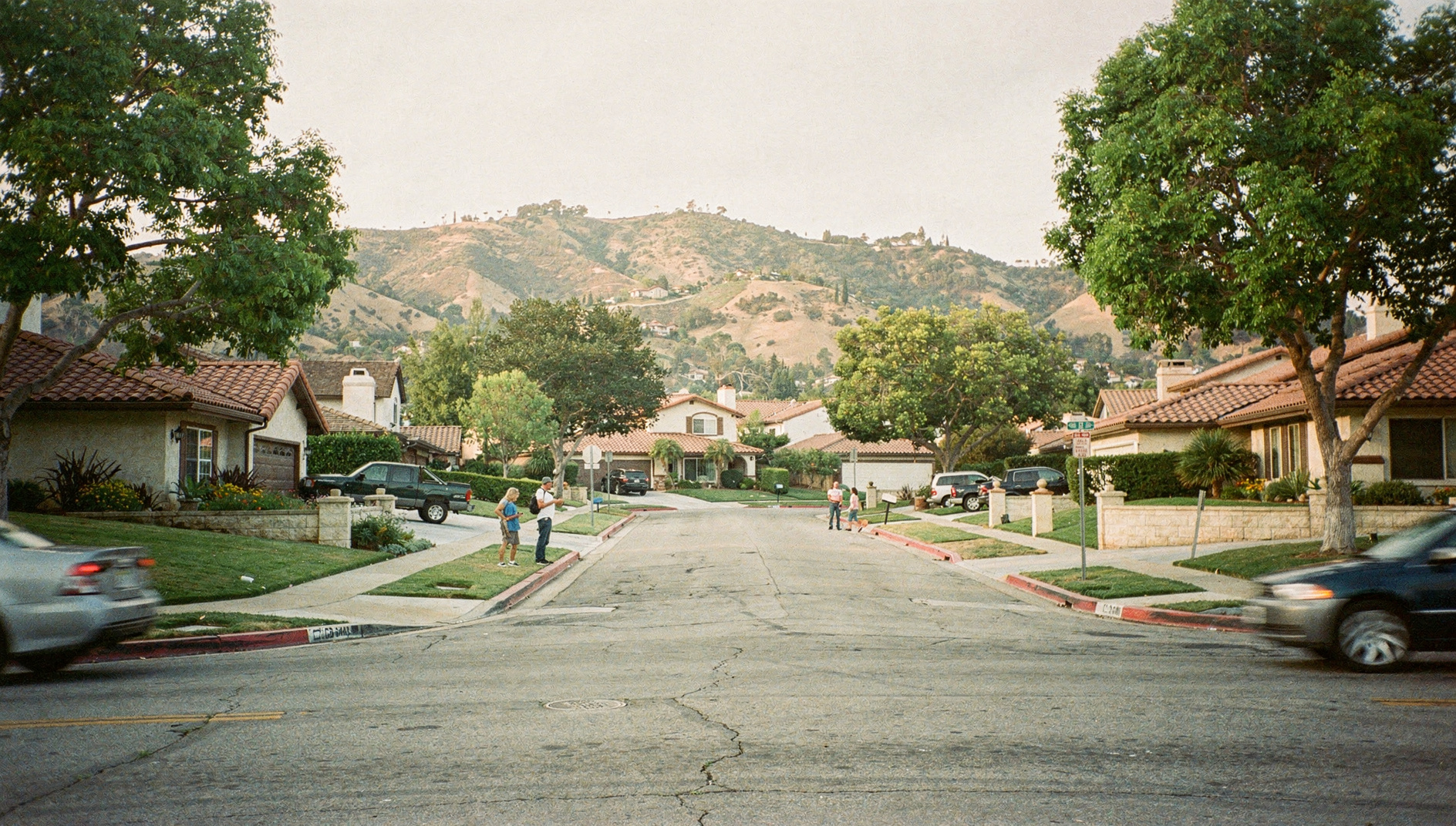 Laguna Hills hillside neighborhood with mature trees, single-family homes, and South Orange County views