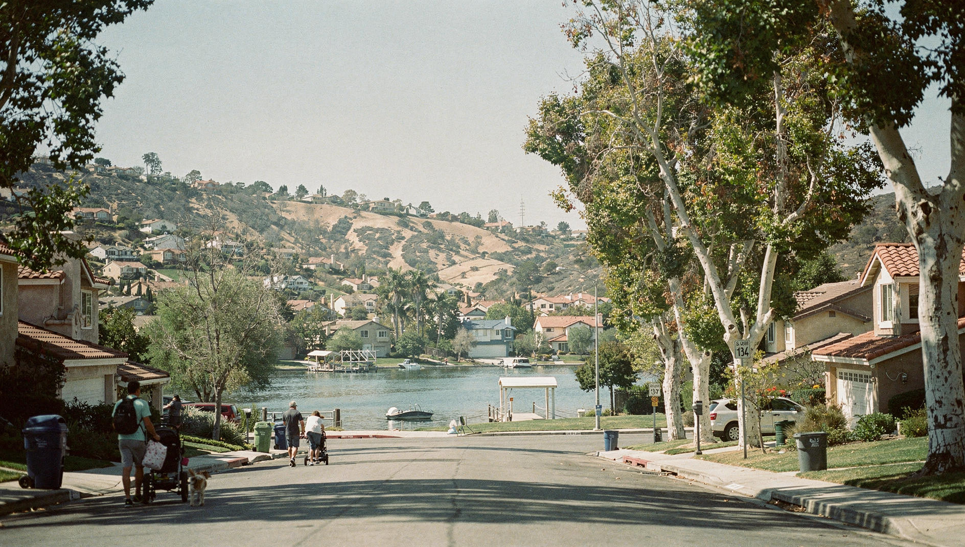Mission Viejo neighborhood with Lake Mission Viejo, rolling hills, and family homes under blue sky